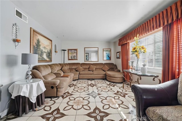 living room with light tile patterned floors and visible vents
