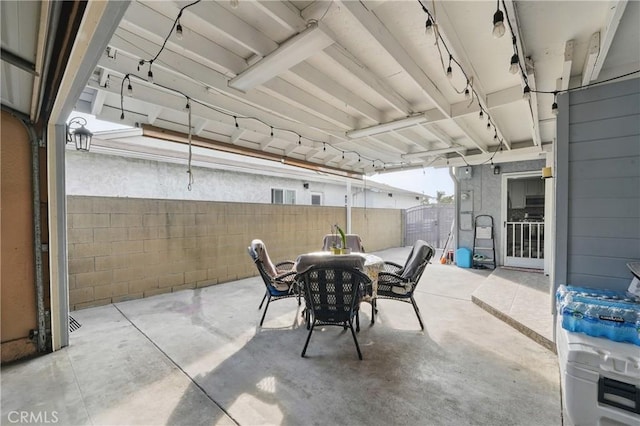 view of patio with outdoor dining area and fence