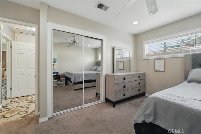 bedroom featuring a closet, visible vents, a ceiling fan, and carpet floors