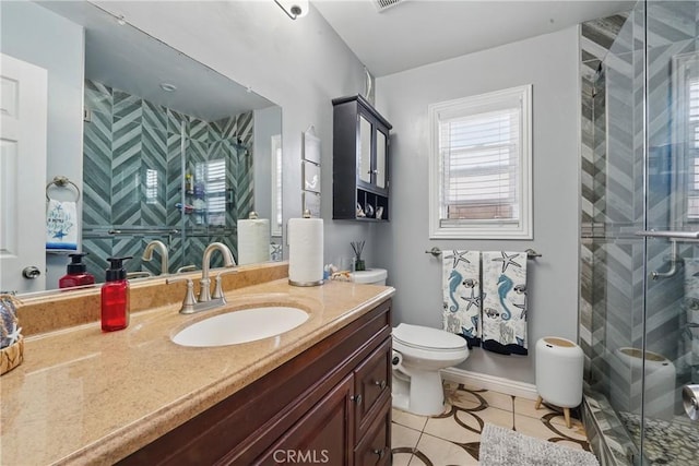 bathroom with toilet, vanity, visible vents, tile patterned flooring, and a shower stall
