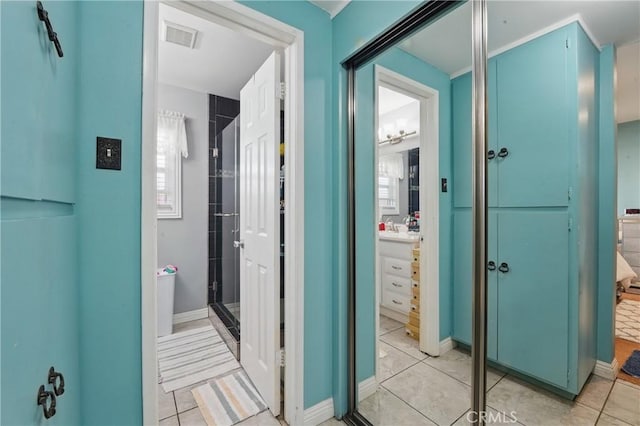 full bathroom with a stall shower, tile patterned flooring, vanity, and visible vents