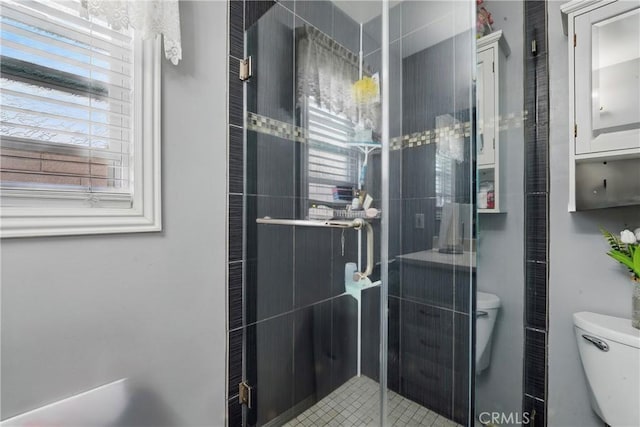 bathroom with toilet and a shower stall