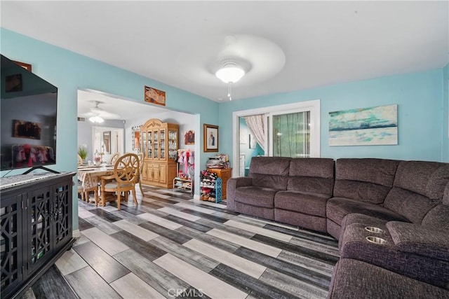 living area featuring ceiling fan and wood finished floors