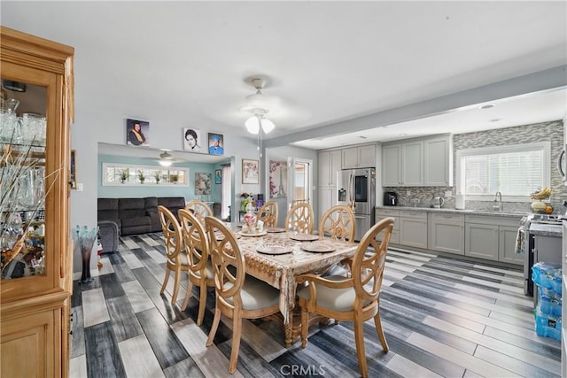 dining area with a ceiling fan and light wood-type flooring