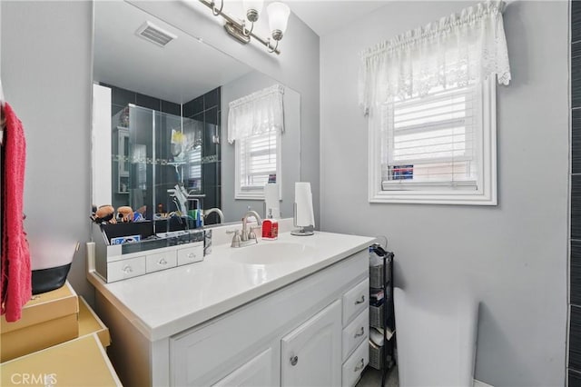 full bathroom featuring vanity, visible vents, and a shower stall