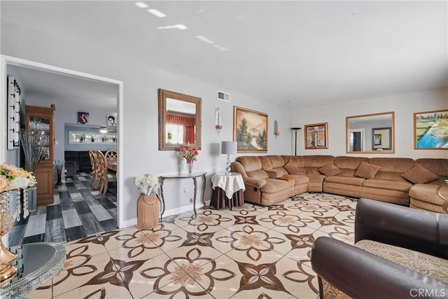 living room featuring tile patterned floors and visible vents