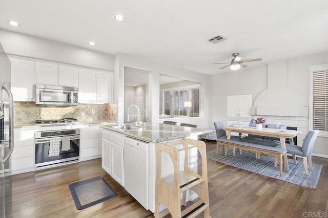 18562 Caminito Pasadero, San Diego, CA 92128 - kitchen featuring a sink, stainless steel appliances, tasteful backsplash, and light stone countertops