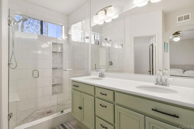 18562 Caminito Pasadero, San Diego, CA 92128 - bathroom featuring a stall shower, visible vents, a sink, and double vanity