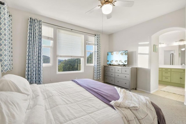 18562 Caminito Pasadero, San Diego, CA 92128 - bedroom featuring ensuite bath, light carpet, arched walkways, a ceiling fan, and baseboards
