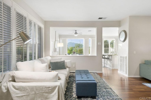 18562 Caminito Pasadero, San Diego, CA 92128 - living area featuring a ceiling fan, baseboards, visible vents, and wood finished floors