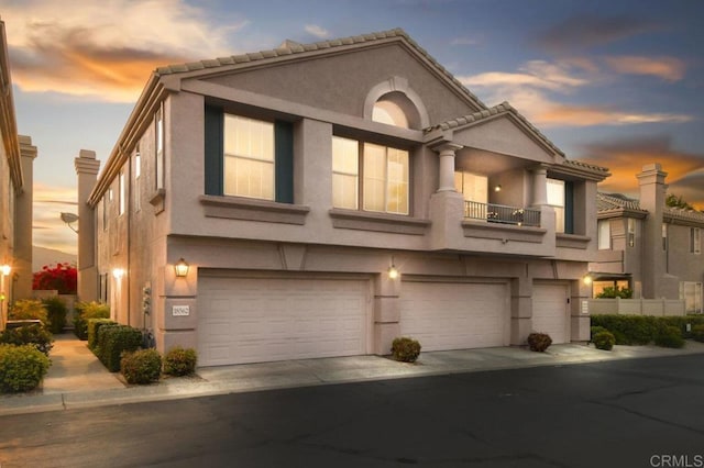 18562 Caminito Pasadero, San Diego, CA 92128 - multi unit property featuring an attached garage, concrete driveway, stucco siding, and a balcony