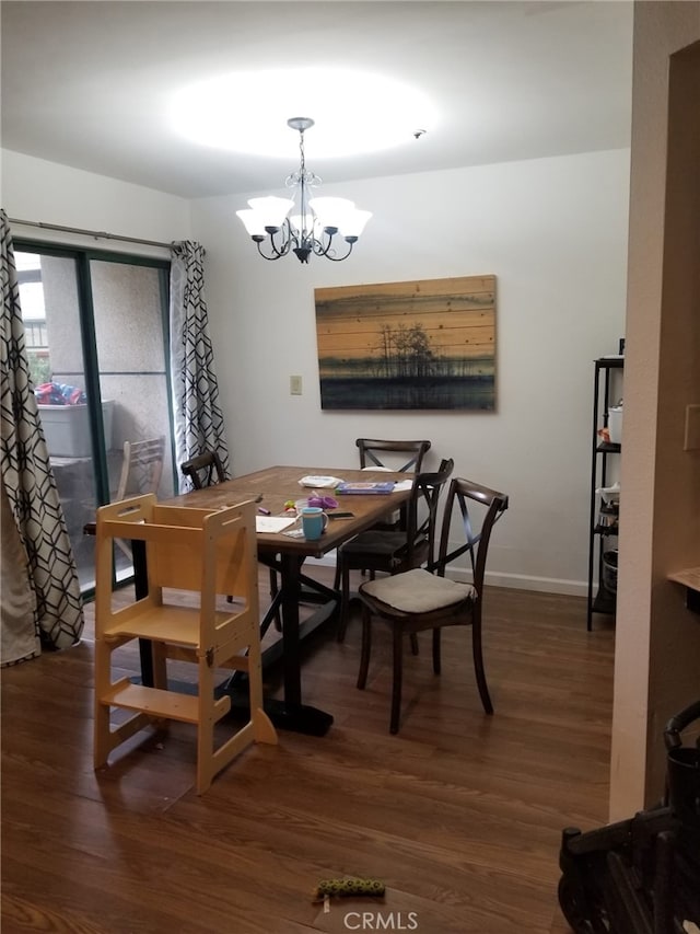 426 N Maryland Ave Unit 103, Glendale, CA 91206 - dining space featuring baseboards, a notable chandelier, and wood finished floors