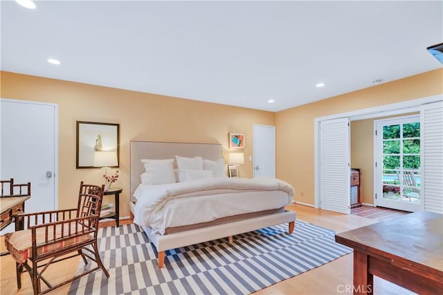 bedroom featuring light wood-style floors, baseboards, access to exterior, and recessed lighting