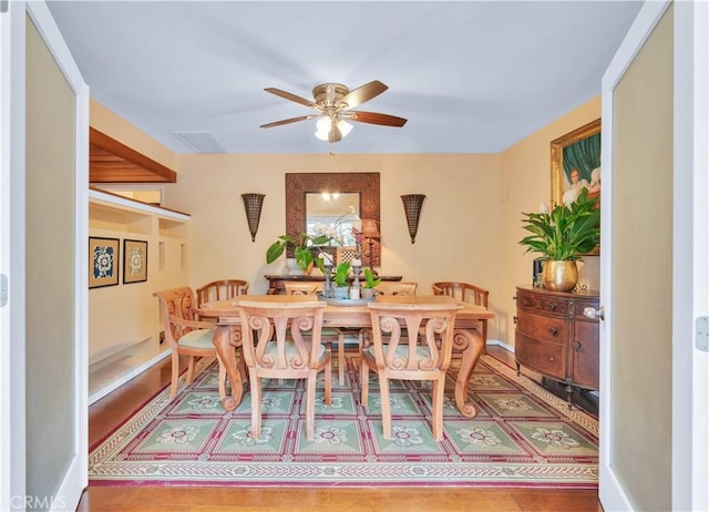 dining space with visible vents, baseboards, and a ceiling fan