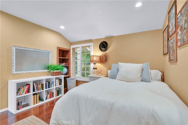 bedroom with baseboards, wood finished floors, lofted ceiling, and recessed lighting