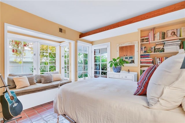 tiled bedroom featuring beam ceiling and visible vents