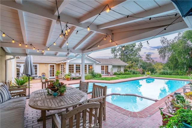 view of pool with a patio area, a pool with connected hot tub, and outdoor dining space