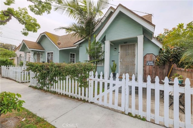 1341 N Fries, Wilmington, CA 90744 - view of front facade with covered porch and a fenced front yard