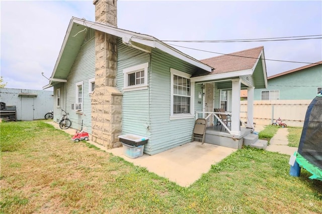 1341 N Fries, Wilmington, CA 90744 - back of property with a yard, fence, a chimney, and a porch
