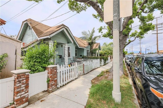 1341 N Fries, Wilmington, CA 90744 - view of side of property featuring a fenced front yard and a gate