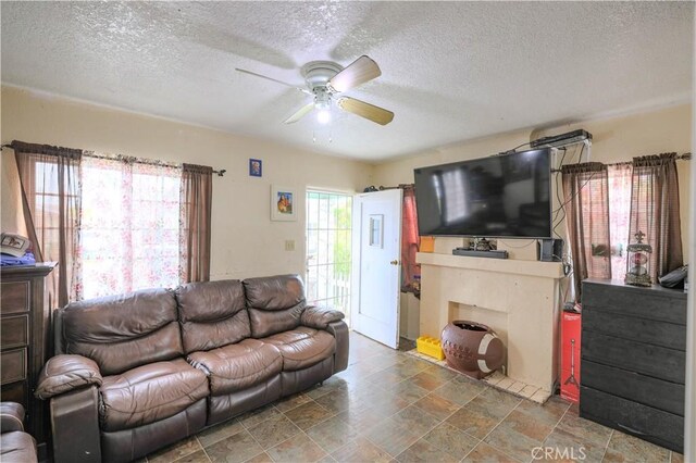 1341 N Fries, Wilmington, CA 90744 - living area featuring a textured ceiling, a ceiling fan, and stone finish floor