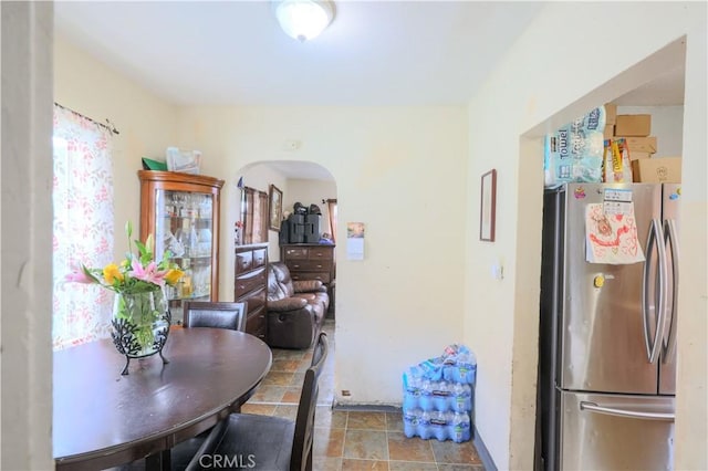 1341 N Fries, Wilmington, CA 90744 - kitchen featuring freestanding refrigerator, stone finish flooring, and arched walkways