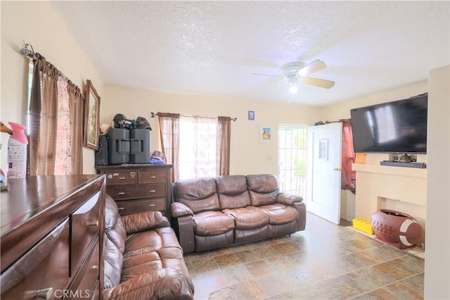 1341 N Fries, Wilmington, CA 90744 - living area with a textured ceiling, stone finish flooring, and ceiling fan