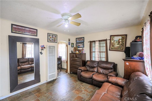 1341 N Fries, Wilmington, CA 90744 - living area with a heating unit, a ceiling fan, and stone finish floor