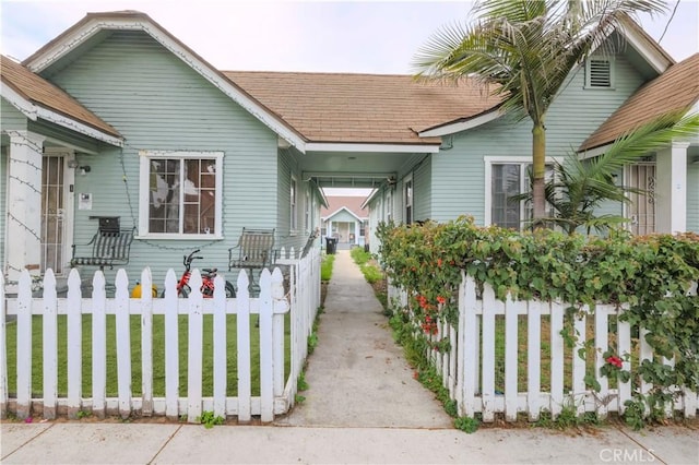 1341 N Fries, Wilmington, CA 90744 - view of front facade featuring a fenced front yard and a shingled roof