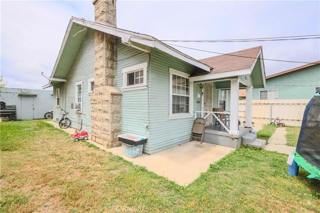 1341 N Fries, Wilmington, CA 90744 - back of property with a yard, fence, covered porch, and a chimney