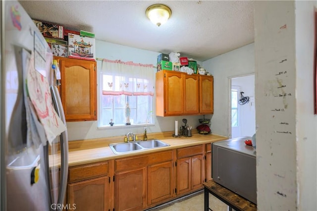 1341 N Fries, Wilmington, CA 90744 - kitchen featuring freestanding refrigerator, light countertops, a textured ceiling, and a sink
