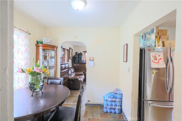 1341 N Fries, Wilmington, CA 90744 - kitchen featuring freestanding refrigerator, stone finish flooring, and arched walkways
