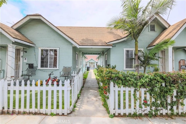 1341 N Fries, Wilmington, CA 90744 - view of front of home featuring fence private yard, a shingled roof, and an attached carport