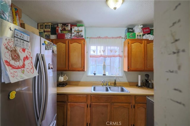 1341 N Fries, Wilmington, CA 90744 - kitchen featuring freestanding refrigerator, light countertops, a sink, and a textured ceiling
