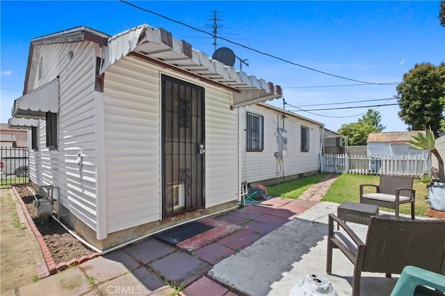 view of outbuilding featuring fence