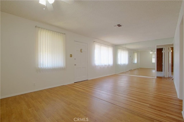4441 W 145th, Lawndale, CA 90260 - unfurnished living room featuring a ceiling fan, light wood-style flooring, a textured ceiling, and baseboards