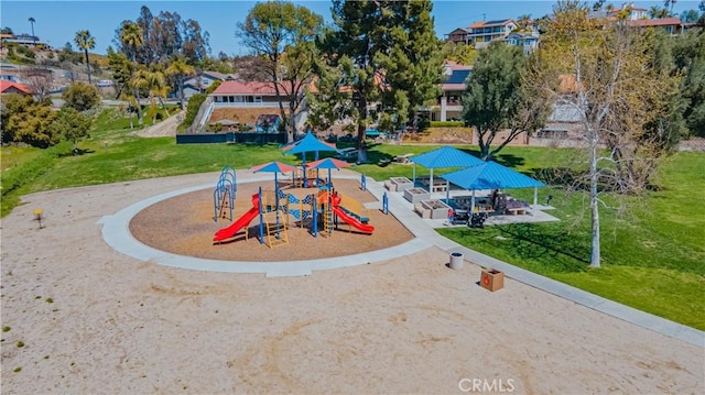 communal playground with a residential view and a lawn