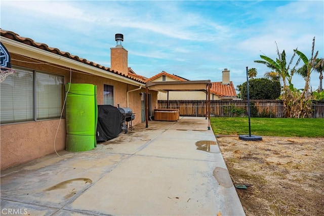 view of patio / terrace featuring a hot tub and a fenced backyard