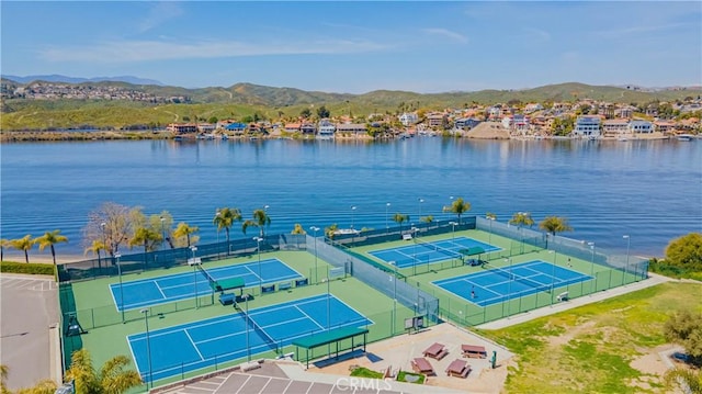 drone / aerial view featuring a water and mountain view and a residential view