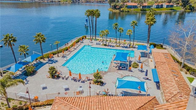 community pool featuring a water view and a patio