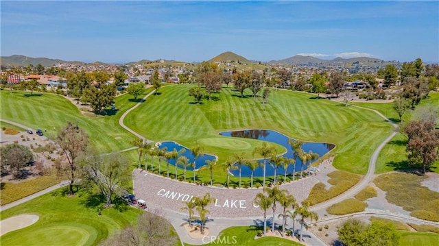 birds eye view of property with a water and mountain view, golf course view, and a residential view