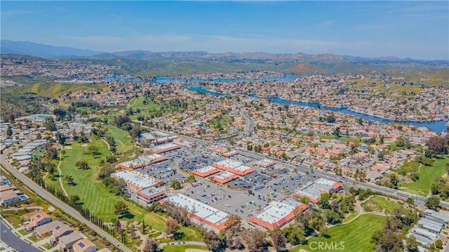 birds eye view of property featuring view of golf course, a residential view, and a water and mountain view