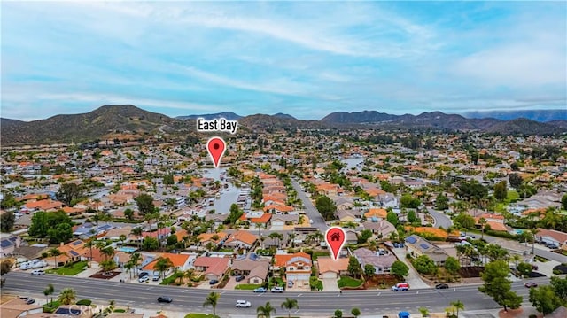 birds eye view of property with a mountain view and a residential view