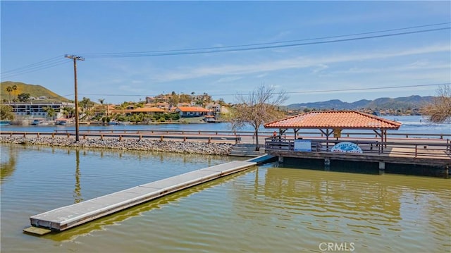 dock area with a water and mountain view and a gazebo