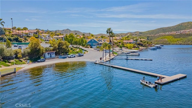 view of water feature featuring a floating dock and a mountain view