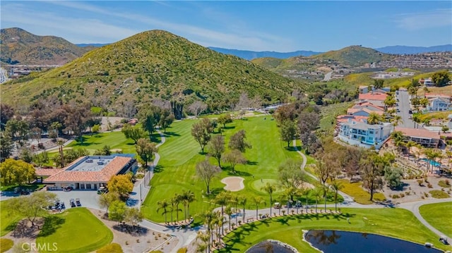 bird's eye view with view of golf course and a water and mountain view