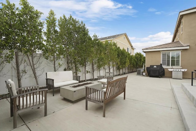 view of patio with an outdoor living space with a fire pit, a fenced backyard, area for grilling, and central AC