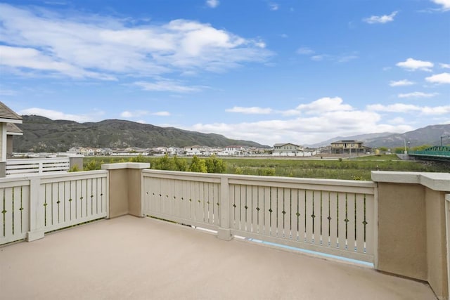 view of patio / terrace featuring a mountain view and a balcony