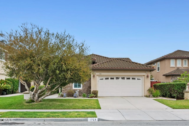 view of front of house featuring an attached garage, stucco siding, driveway, and a front lawn