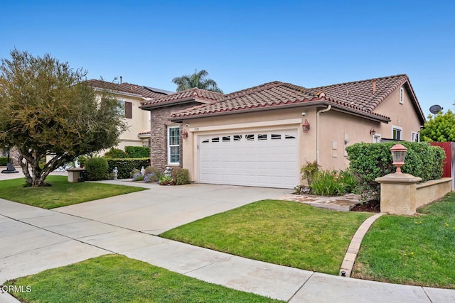 mediterranean / spanish home with a front lawn, driveway, and a garage